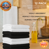 Stack of white and black kitchen towels with promotional text on a wooden surface.