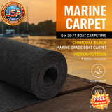 Roll of marine carpet with promotional text and logos on a wooden surface.